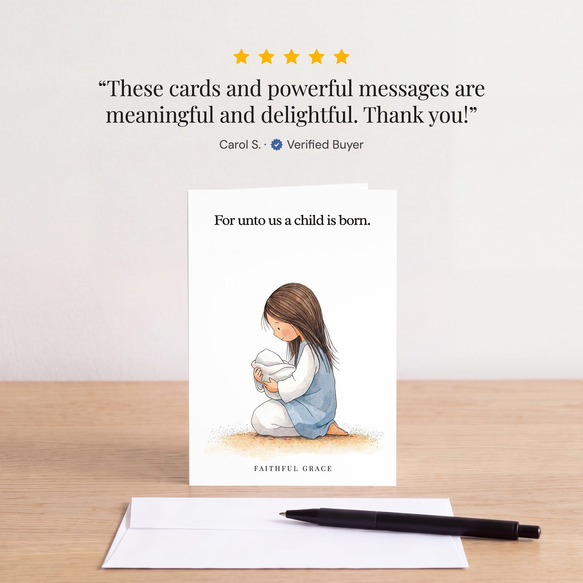 The For unto us a child is born card on a table with a white envelope. Review: "These cards and powerful messages are meaningful and delightful. Thank you!" Carol S.