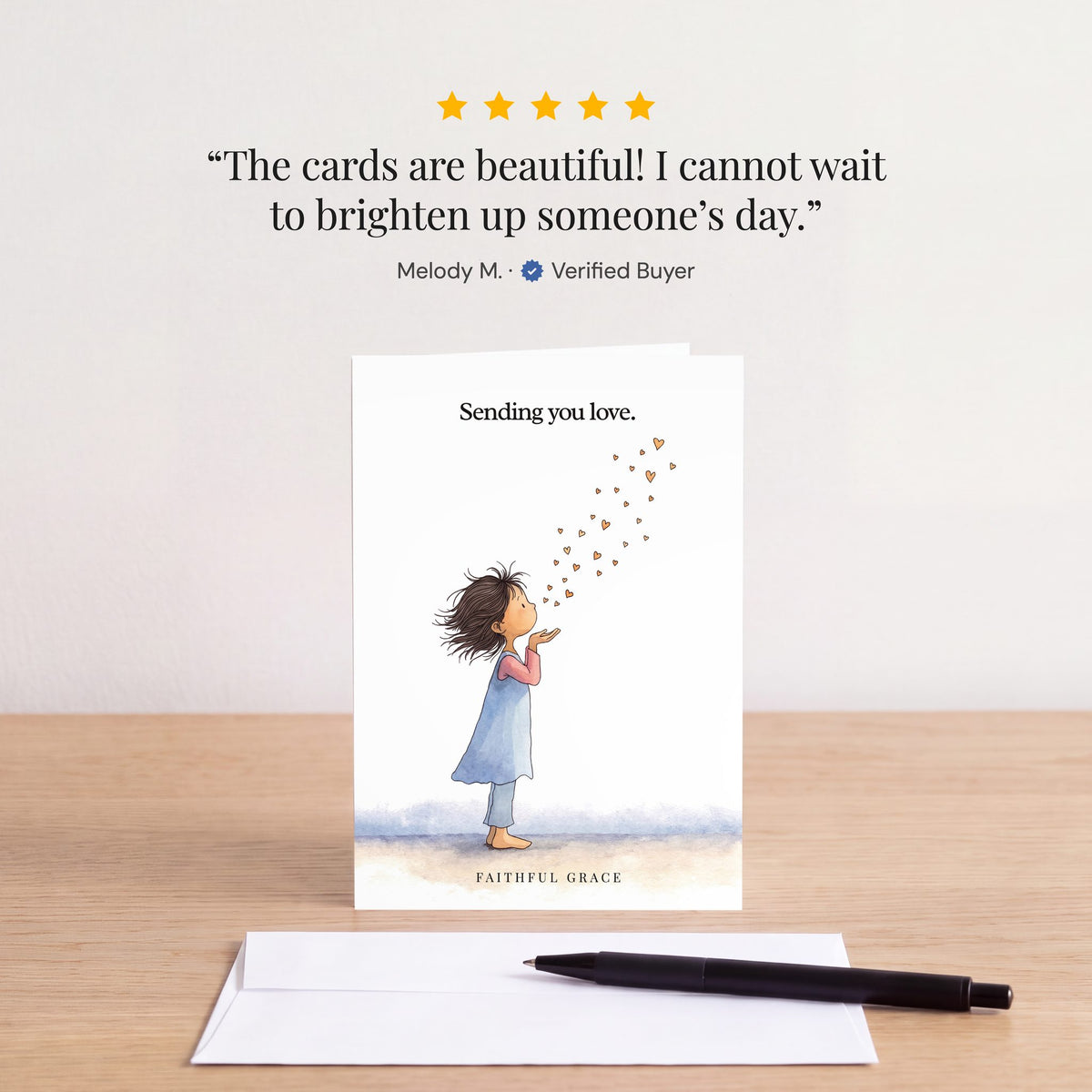 The Sending you love card on a table with a white envelope. Review: "The cards are beautiful! I cannot wait to brighten up someone’s day." Melody M.