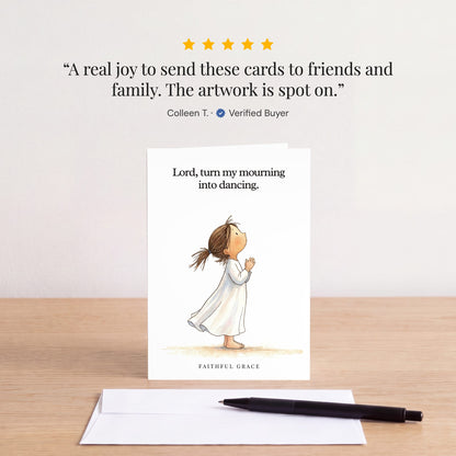 The Turn my mourning into dancing card on a table with a white envelope. Review: "A real joy to send these cards to friends and family. The artwork is spot on." Colleen T.