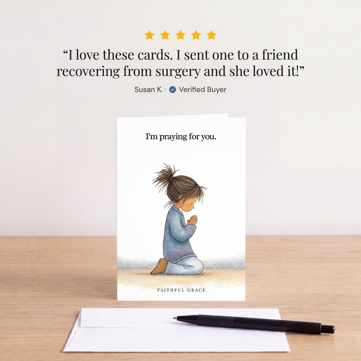 The I'm praying for you card on a table with a white envelope. Review: "I love these cards. I sent one to a friend recovering from surgery and she loved it!" Susan K.