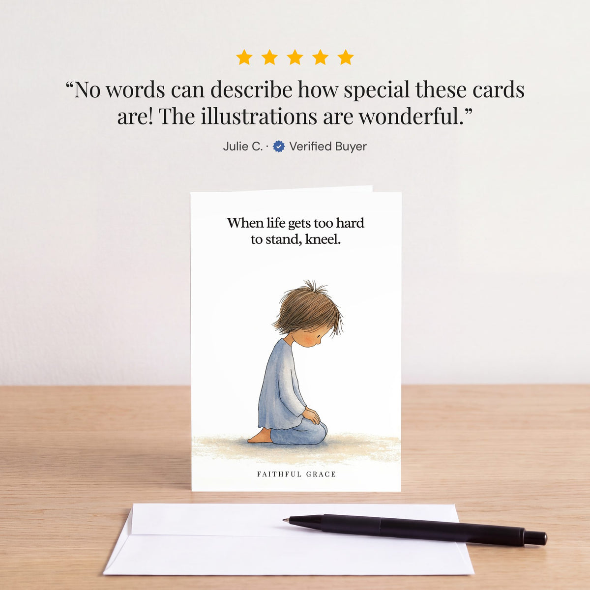 The Kneel card on a table with a white envelope. Review: "No words can describe how special these cards are! The illustrations are wonderful." Julie C.