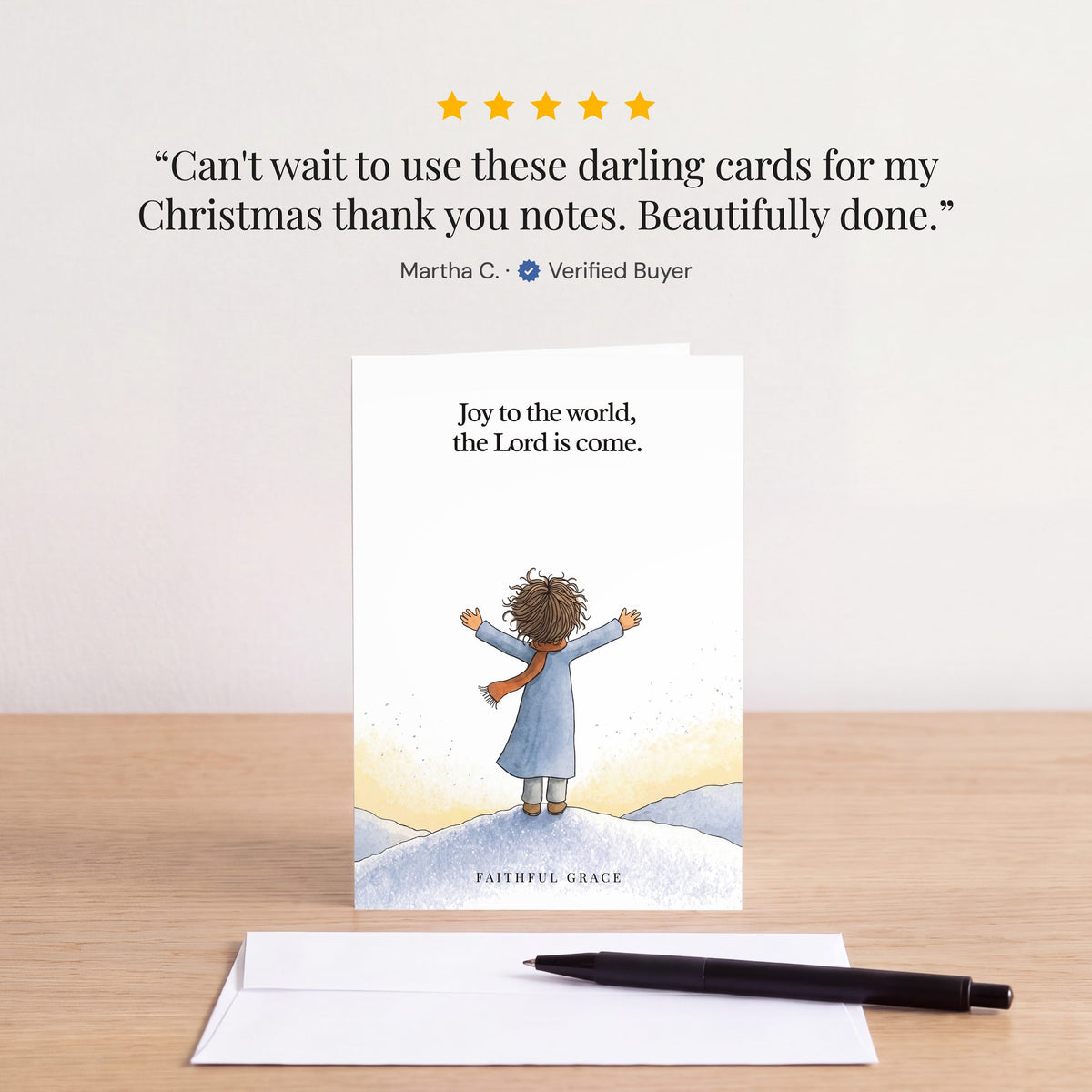 The Joy to the world card on a table with a white envelope. Review: "Can't wait to use these darling cards for my Christmas thank you notes. Beautifully done." Martha C.