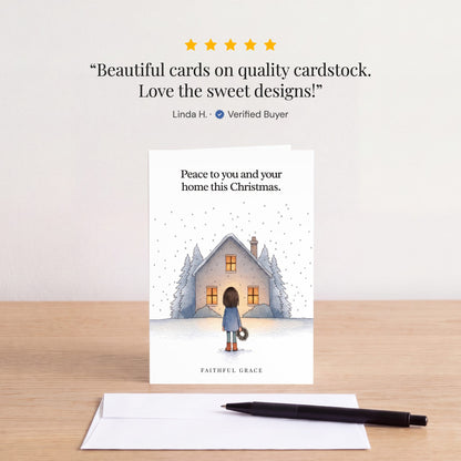 The Peace to you and your home card on a table with a white envelope. Review: "Beautiful cards on quality cardstock. Love the sweet designs!" Linda H.