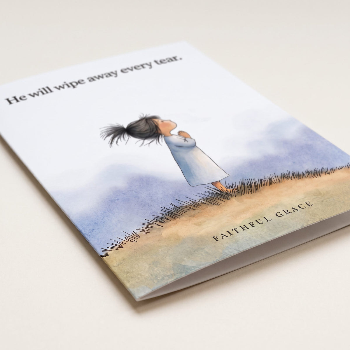 Close-up of the He will wipe away every tear card showing the smooth matte finish and fold