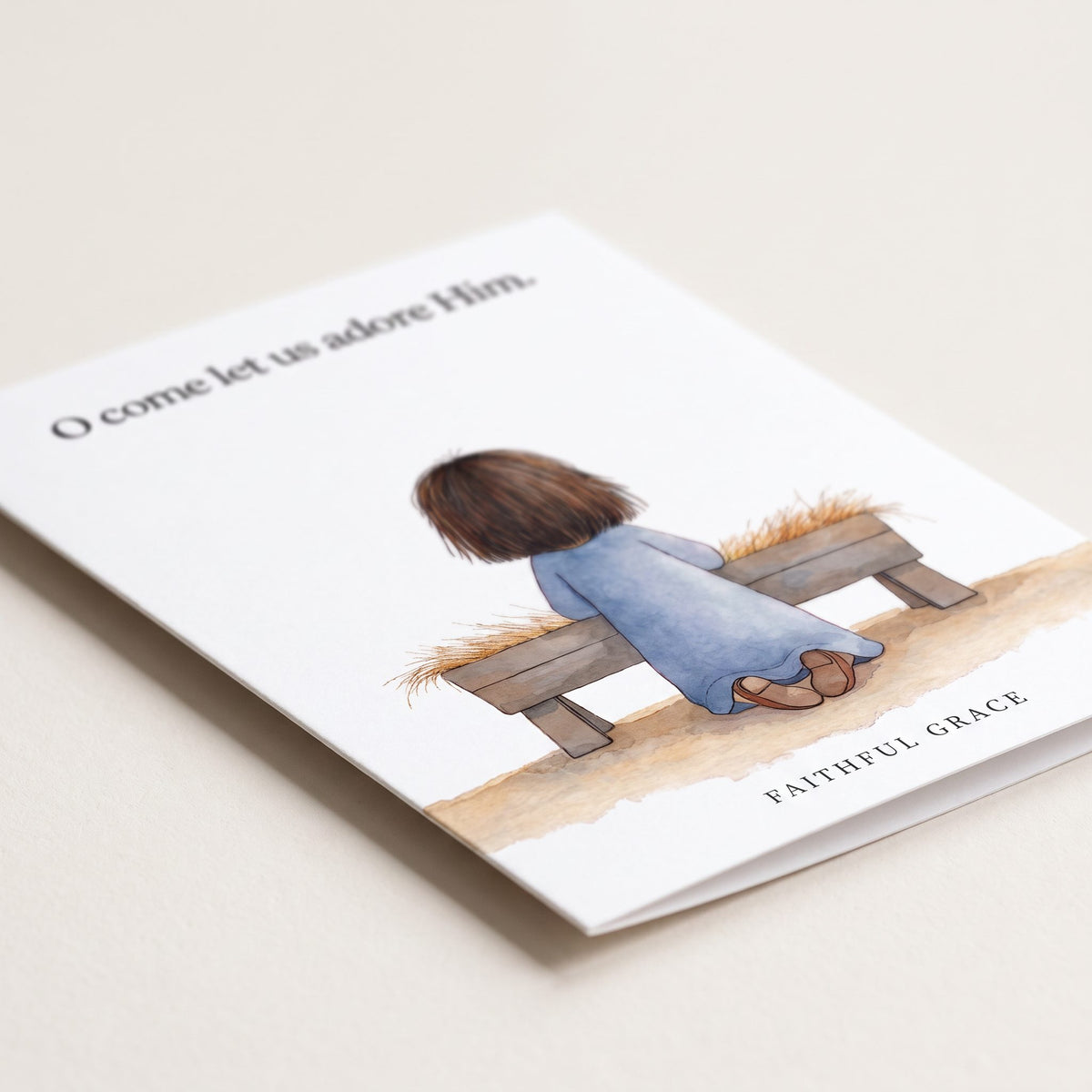 Close-up of the O come let us adore Him card showing the smooth matte finish and fold