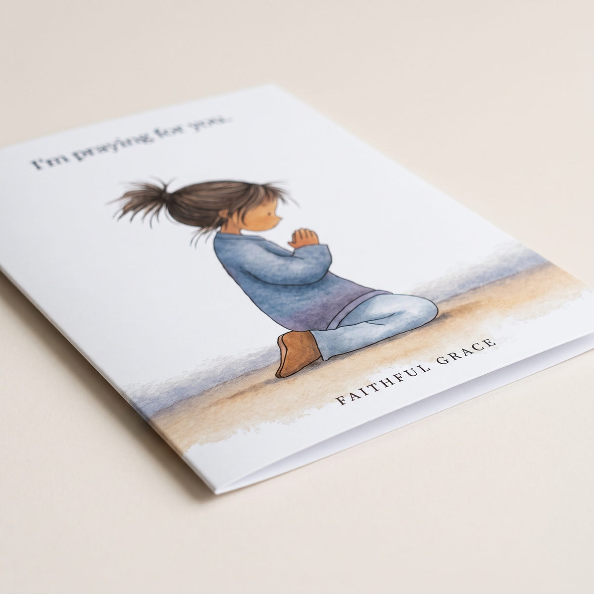 Close-up of the I'm praying for you card showing the smooth matte finish and fold
